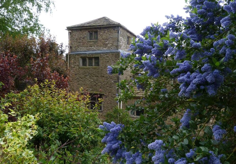 The Folly's tower surrounded by the gardens in bloom