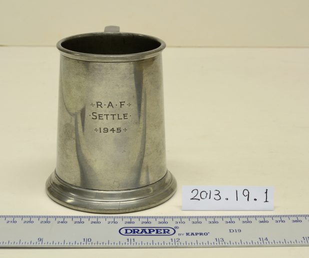 A silver tankard inscribed "RAF Settle 1945"