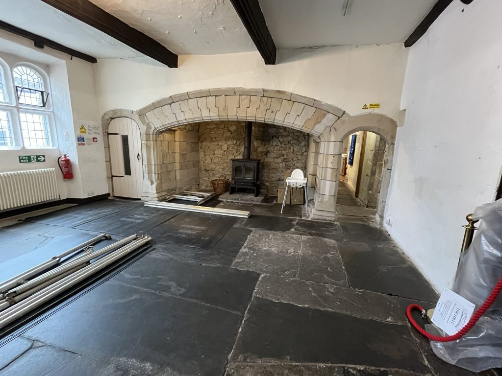 The Hall at The Folly showing floor protection in place in front of the fireplace